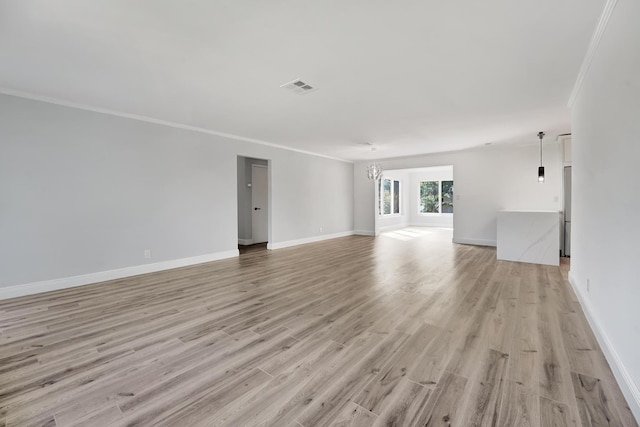 unfurnished living room featuring ornamental molding, light wood-type flooring, and a notable chandelier