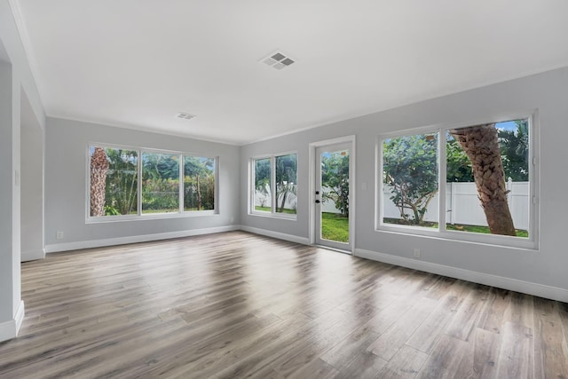524 Lighthouse Dr, North Palm Beach, FL 33408 - unfurnished living room featuring baseboards and wood finished floors