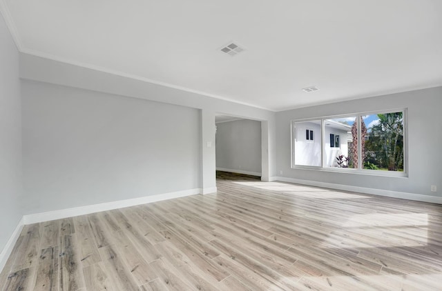 unfurnished room with light hardwood / wood-style flooring and crown molding