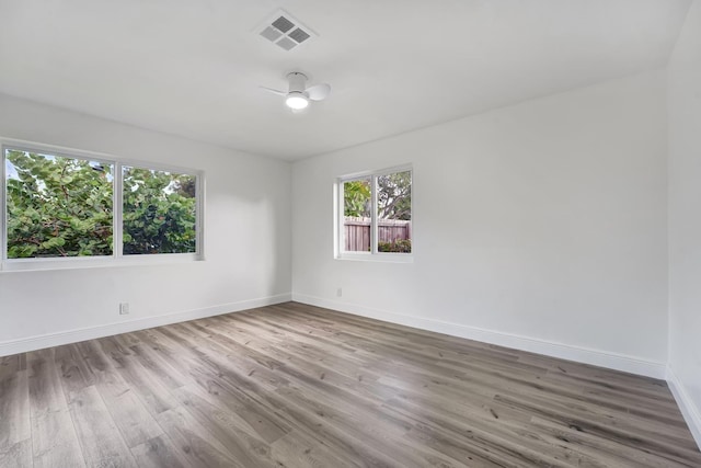 unfurnished room with ceiling fan and wood-type flooring