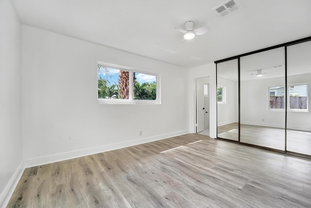 unfurnished bedroom featuring a closet, ceiling fan, and light hardwood / wood-style floors