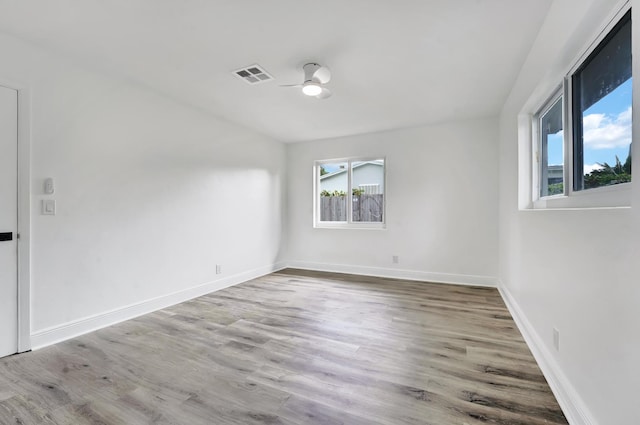 empty room featuring ceiling fan and light hardwood / wood-style flooring