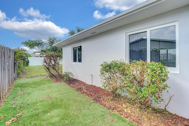 view of side of property with a lawn