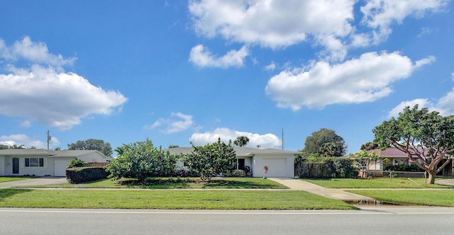 single story home featuring a garage and a front lawn