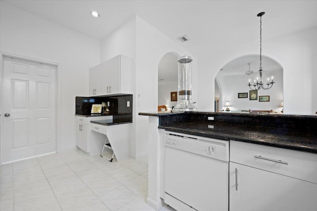 kitchen featuring an inviting chandelier, white cabinetry, white dishwasher, dark stone countertops, and pendant lighting