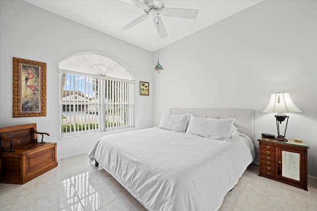 tiled bedroom with ceiling fan and lofted ceiling