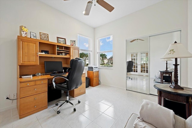 tiled home office featuring ceiling fan and french doors