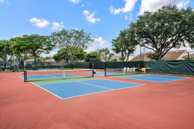 view of tennis court with basketball hoop