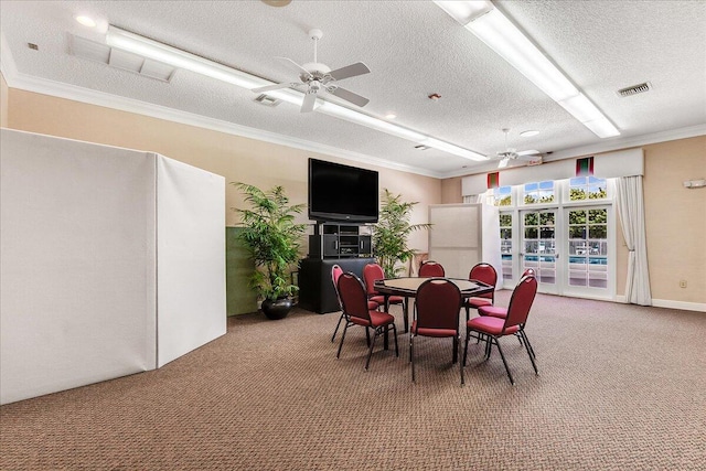 carpeted dining space with ceiling fan, a textured ceiling, and ornamental molding