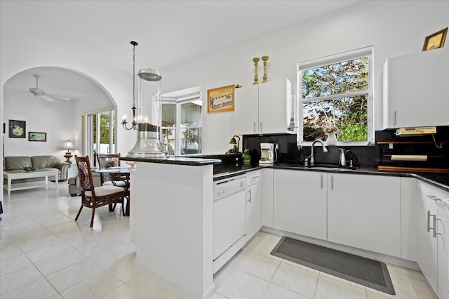 kitchen with white cabinetry, sink, dishwasher, and decorative light fixtures