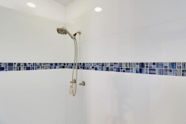 interior details featuring a tile shower