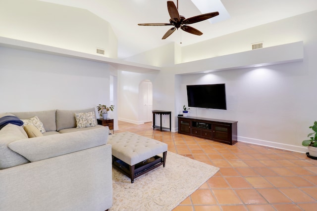 living room with high vaulted ceiling, light tile patterned flooring, and ceiling fan