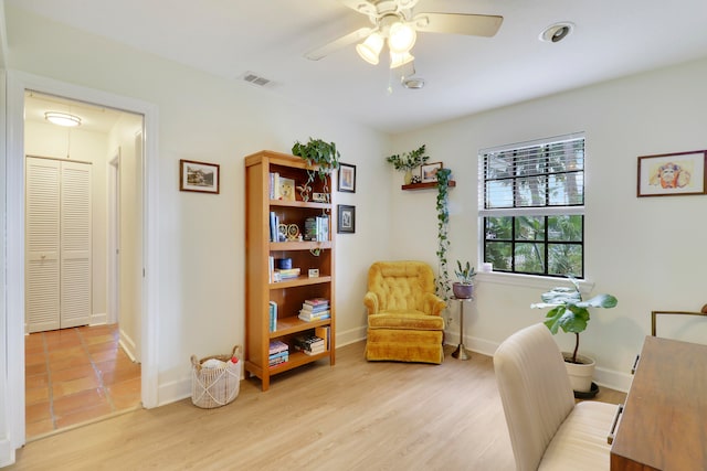 home office featuring ceiling fan and light hardwood / wood-style floors