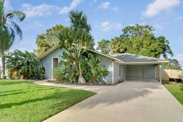 view of front of property with a front yard and a carport