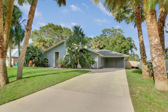 single story home with a garage and a front lawn