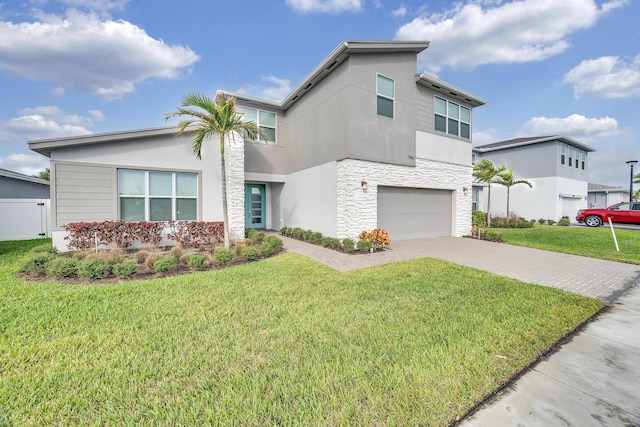 11461 SW Lyra Dr, Port Saint Lucie, FL 34987 - view of front of property with stone siding, driveway, a garage, a front yard, and stucco siding