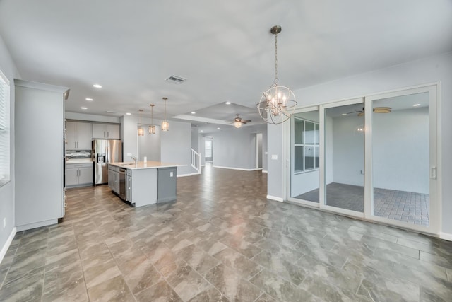 11461 SW Lyra Dr, Port Saint Lucie, FL 34987 - kitchen with ceiling fan, stainless steel appliances, gray cabinetry, a chandelier, and open floor plan