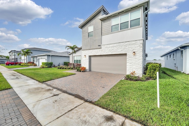 11461 SW Lyra Dr, Port Saint Lucie, FL 34987 - view of front of property with stone siding, a garage, stucco siding, decorative driveway, and a front lawn