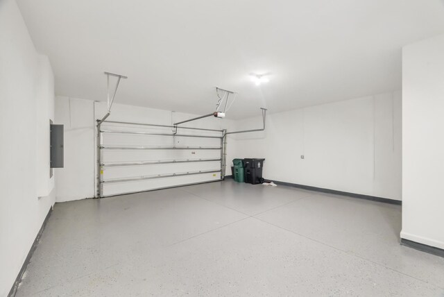 11461 SW Lyra Dr, Port Saint Lucie, FL 34987 - garage featuring electric panel, a garage door opener, and baseboards
