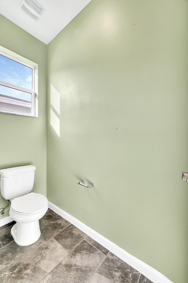 11461 SW Lyra Dr, Port Saint Lucie, FL 34987 - bathroom featuring baseboards and toilet