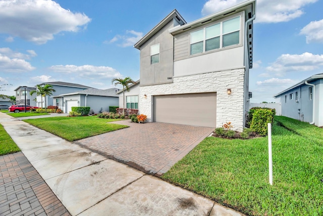 view of front of house with a front yard and a garage