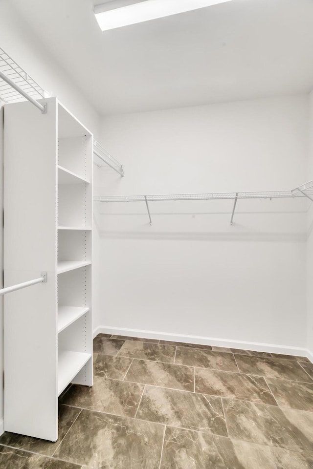 11461 SW Lyra Dr, Port Saint Lucie, FL 34987 - walk in closet featuring stone finish floors