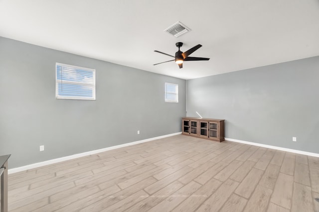 11461 SW Lyra Dr, Port Saint Lucie, FL 34987 - spare room with a ceiling fan, light wood-style floors, and baseboards