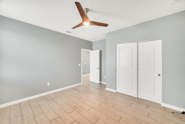 11461 SW Lyra Dr, Port Saint Lucie, FL 34987 - unfurnished bedroom with light wood-style flooring, baseboards, a closet, and a ceiling fan