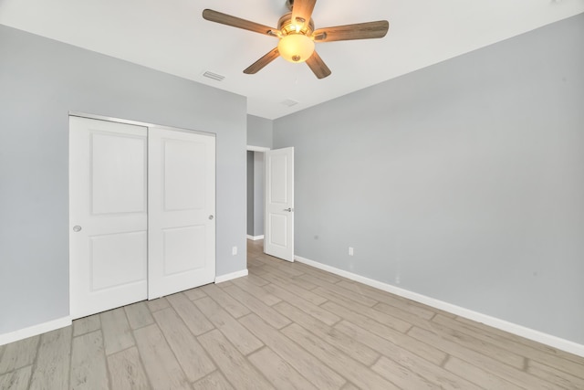 11461 SW Lyra Dr, Port Saint Lucie, FL 34987 - unfurnished bedroom featuring light wood-style flooring, baseboards, a closet, and a ceiling fan