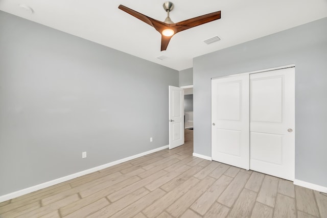 11461 SW Lyra Dr, Port Saint Lucie, FL 34987 - unfurnished bedroom with light wood-style flooring, baseboards, a closet, and a ceiling fan