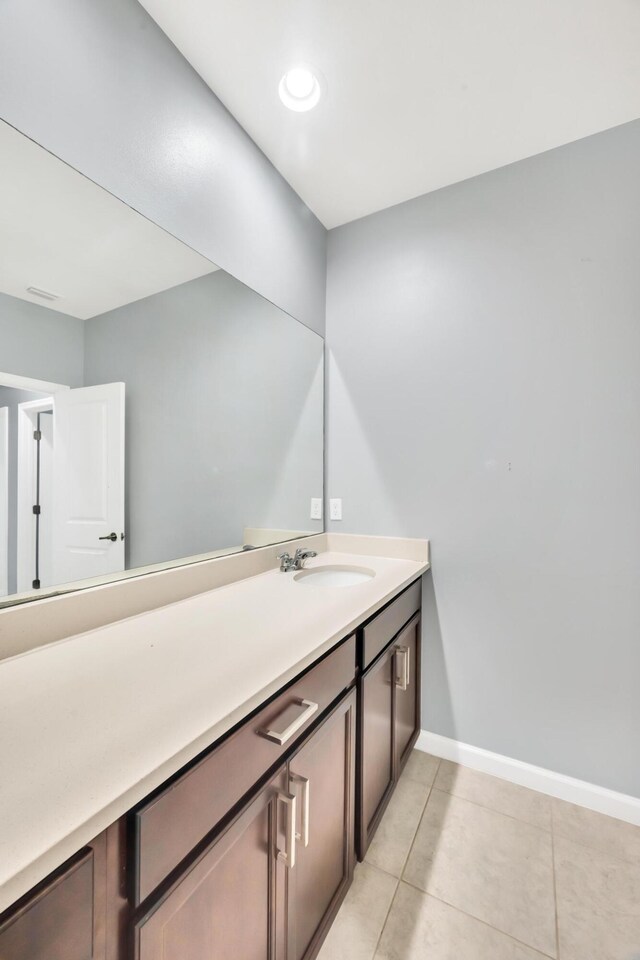 11461 SW Lyra Dr, Port Saint Lucie, FL 34987 - bathroom featuring tile patterned floors, baseboards, and vanity