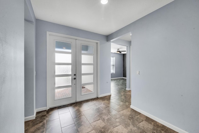 11461 SW Lyra Dr, Port Saint Lucie, FL 34987 - foyer entrance featuring french doors, baseboards, and ceiling fan