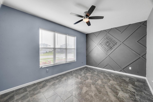 11461 SW Lyra Dr, Port Saint Lucie, FL 34987 - empty room featuring baseboards, a ceiling fan, and stone finish flooring