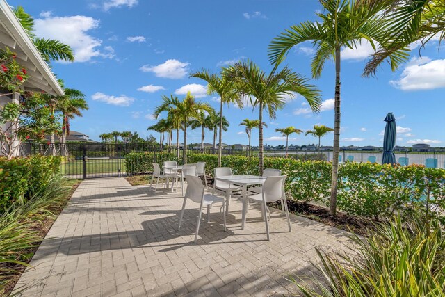 11461 SW Lyra Dr, Port Saint Lucie, FL 34987 - view of patio with outdoor dining area and fence
