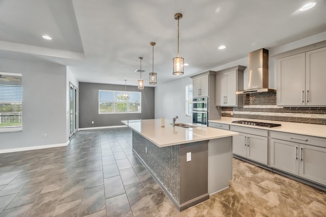 11461 SW Lyra Dr, Port Saint Lucie, FL 34987 - kitchen featuring wall chimney exhaust hood, gray cabinetry, stainless steel appliances, a sink, and baseboards
