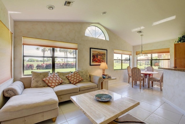 tiled living room with plenty of natural light and lofted ceiling