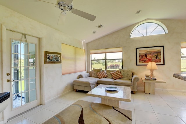 tiled living room with ceiling fan and lofted ceiling