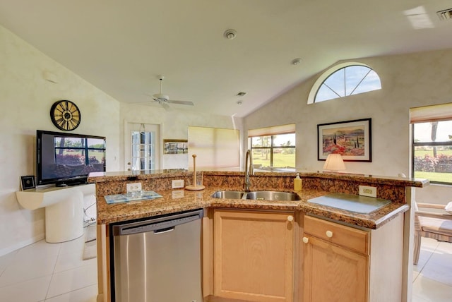 kitchen featuring dishwasher, lofted ceiling, a kitchen island with sink, sink, and a wealth of natural light