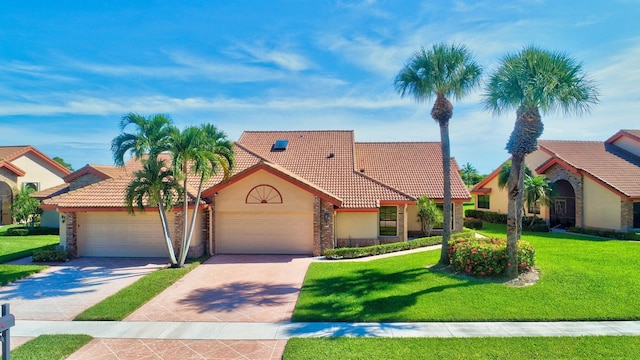 view of front of property with a garage and a front lawn