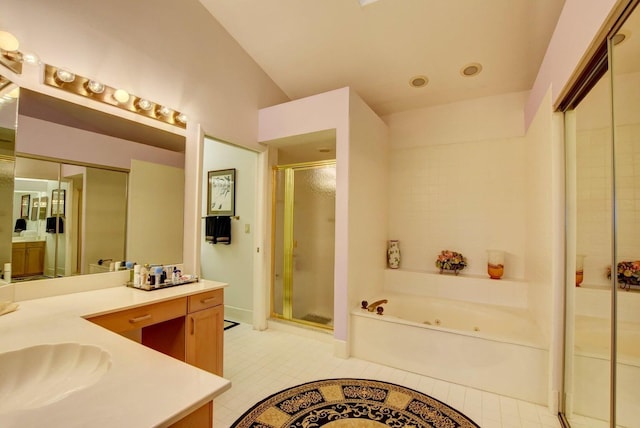 bathroom with tile patterned flooring, vanity, and separate shower and tub