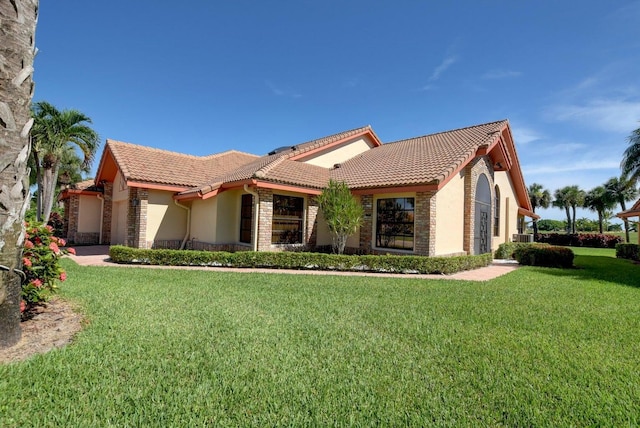 mediterranean / spanish home with a front yard