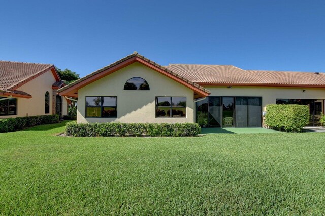 rear view of property with a yard