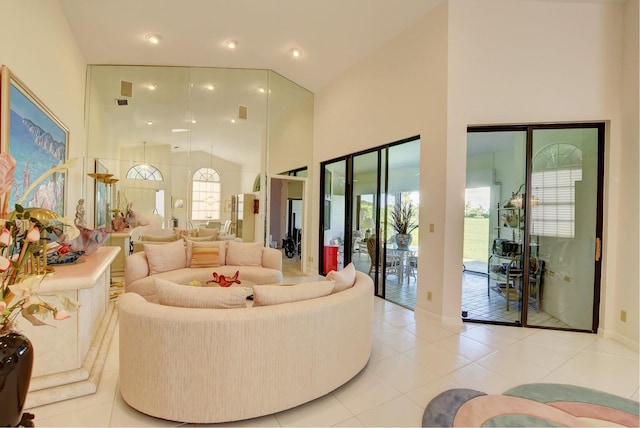 living room featuring light tile patterned floors and high vaulted ceiling