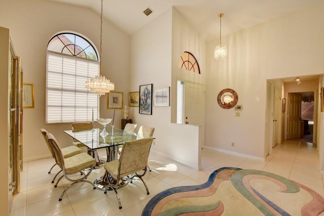 dining space with light tile patterned floors and high vaulted ceiling