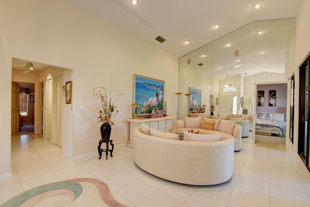 living room featuring high vaulted ceiling and light tile patterned flooring