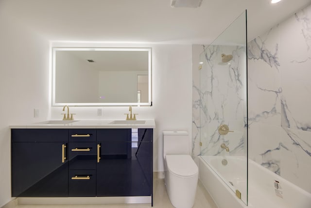 full bathroom featuring toilet, vanity, and tiled shower / bath