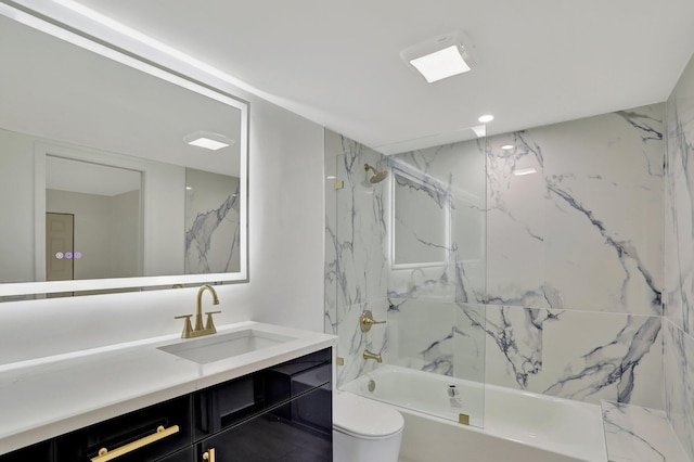 full bathroom with vanity, tiled shower / bath combo, and toilet