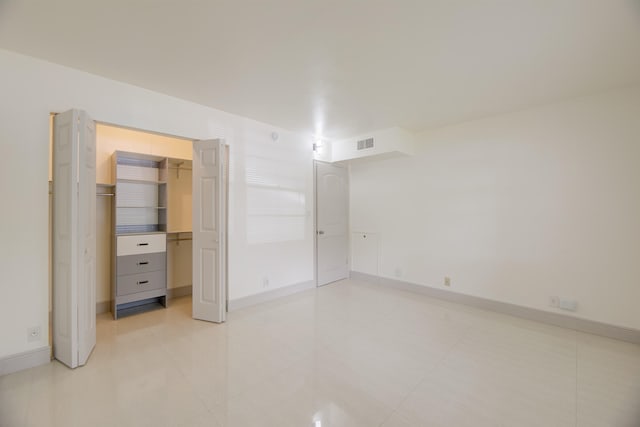 unfurnished bedroom featuring a closet and light tile patterned floors