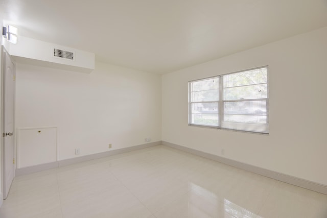 empty room with light tile patterned floors