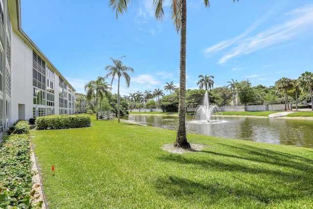 view of home's community featuring a water view and a yard